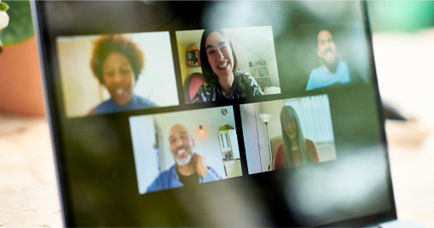 A computer monitor displaying five people on a virtual meeting